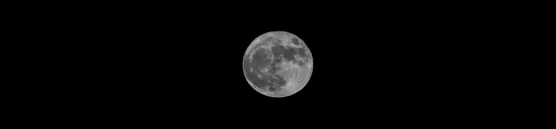 Low angle view of moon against sky at night