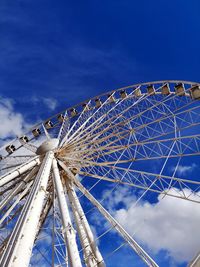 Low angle view of ferris wheel against blue sky