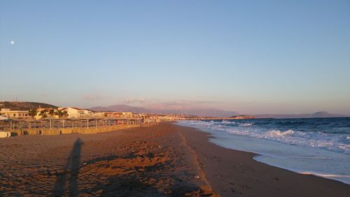 Scenic view of beach against sky during sunset