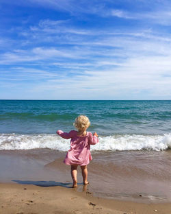 Rear view of girl walking on beach