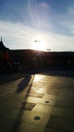 Street against sky at sunset