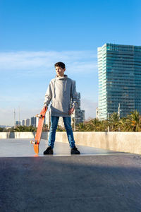 Young skater teen standing on ramp ready to start riding