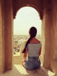 Rear view of woman looking at buildings