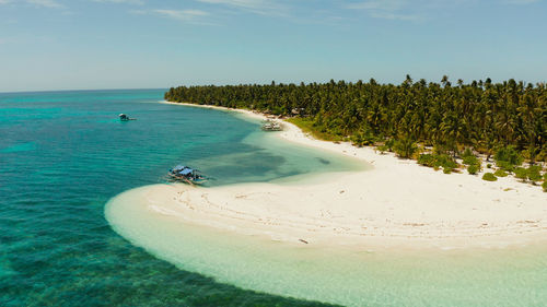 Sandy beach and tropical island by atoll with coral reef. patongong island with sandy beach