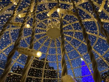 Low angle view of illuminated chandelier hanging in building