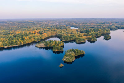 High angle view of lake against sky. islands with fall color forest and blue water.
