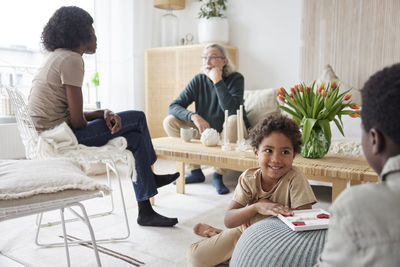 Family relaxing and playing games at home