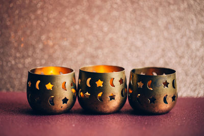 Close-up of illuminated candles on table