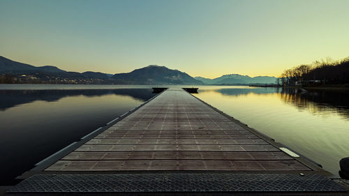 Pier over lake against clear sky