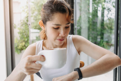 Mid adult man holding coffee cup