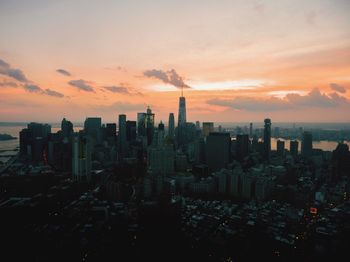 Aerial view of cityscape against sky during sunset 