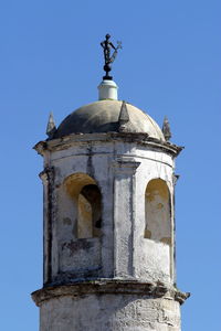 Low angle view of built structure against clear blue sky