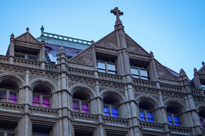 Low angle view of historical building against blue sky