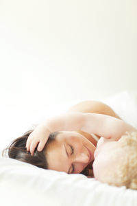 Mother with baby in bed, close-up