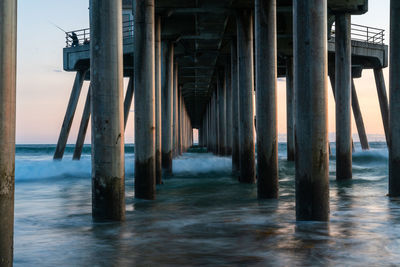 Wooden pier on sea against sky