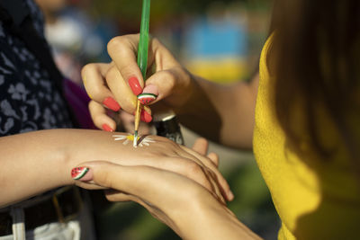 Midsection of woman holding hands