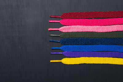 Directly above shot of multi colored drinking straws against black background