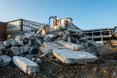 Stack of abandoned metal structure against sky