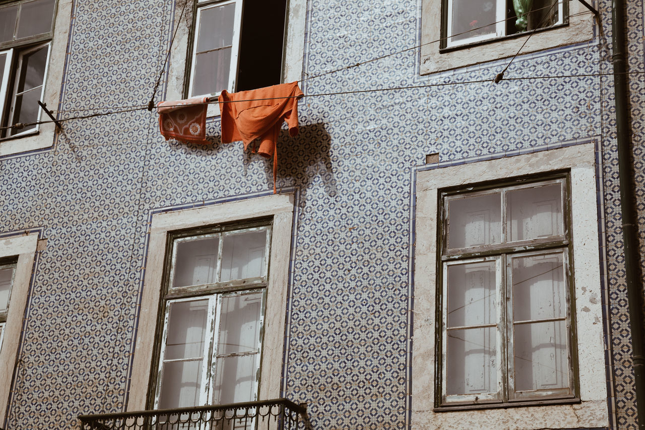 LOW ANGLE VIEW OF CLOTHES HANGING ON WALL