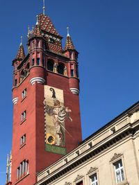 Low angle view of clock tower against blue sky