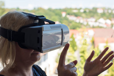 Close-up of senior woman gesturing while using virtual reality simulator