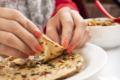 Close-up of hand holding pizza