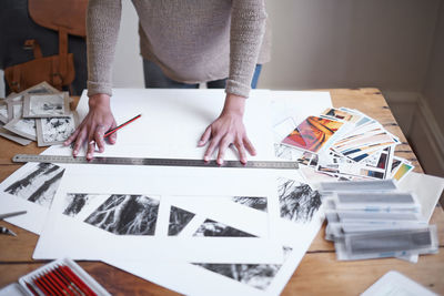 Midsection of man working on table