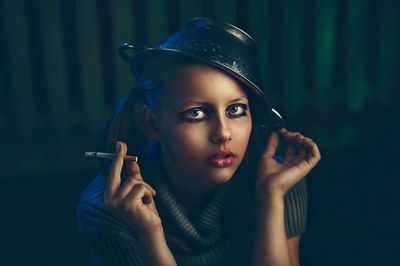 Close-up portrait of young woman smoking cigarette