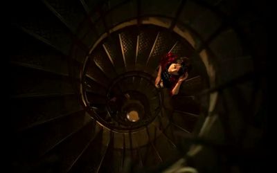 High angle view of woman standing on spiral staircase