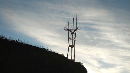 Low angle view of silhouette electricity pylon against sky