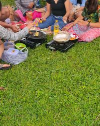 High angle view of people sitting on grass