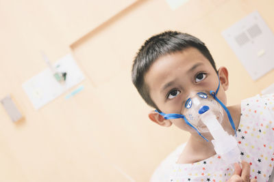 Boy wearing oxygen mask in hospital