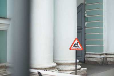 Close-up of arrow sign against building