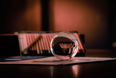 Close-up of crystal ball on glass table