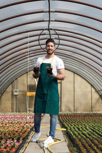 Full length of man standing in greenhouse