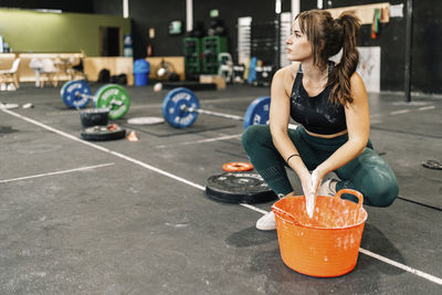 Young woman sitting on the road