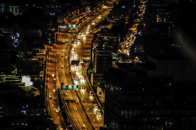 High angle view of city lit up at night