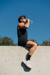 Man wearing sunglasses against clear blue sky