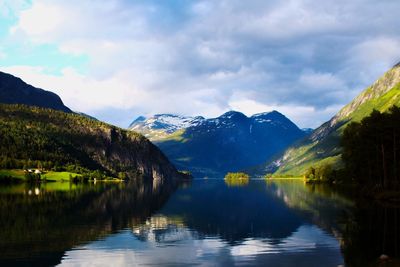 Scenic view of lake and mountains against sky