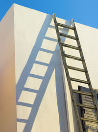 Low angle view of ladder against building