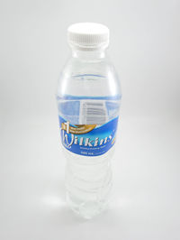 Close-up of glass bottle against white background