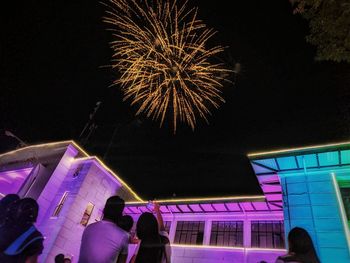 Low angle view of firework display at night