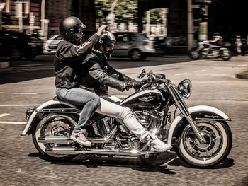 Blurred motion of man riding motorcycle on street