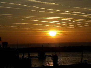 Scenic view of sea against orange sky