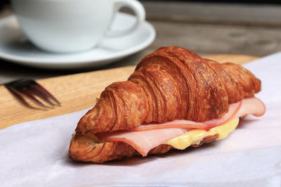 Close-up of bread with coffee served on table