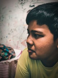 Portrait of young man looking away at home