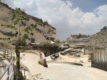 Panoramic shot of building by road against sky