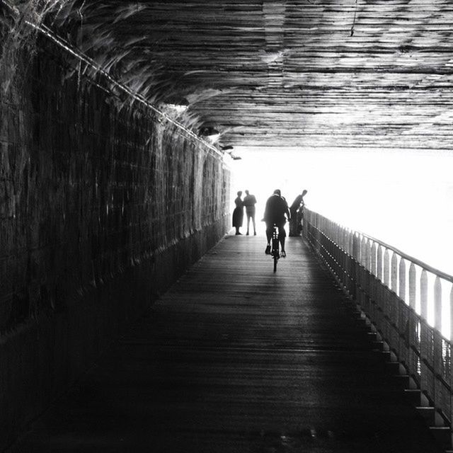 walking, men, the way forward, lifestyles, full length, rear view, leisure activity, person, togetherness, diminishing perspective, indoors, bonding, built structure, architecture, boys, day, vanishing point