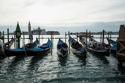 Gondolas moored on grand canal in city