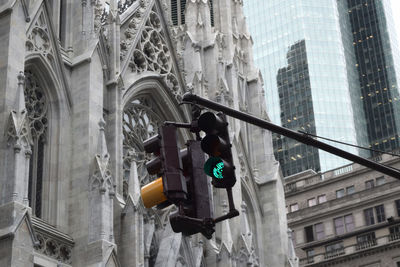 High section of traffic light against built structure